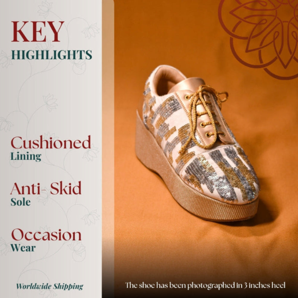 Beige wedge sneaker with gold silver sequins and lace up detail on a textured platform.