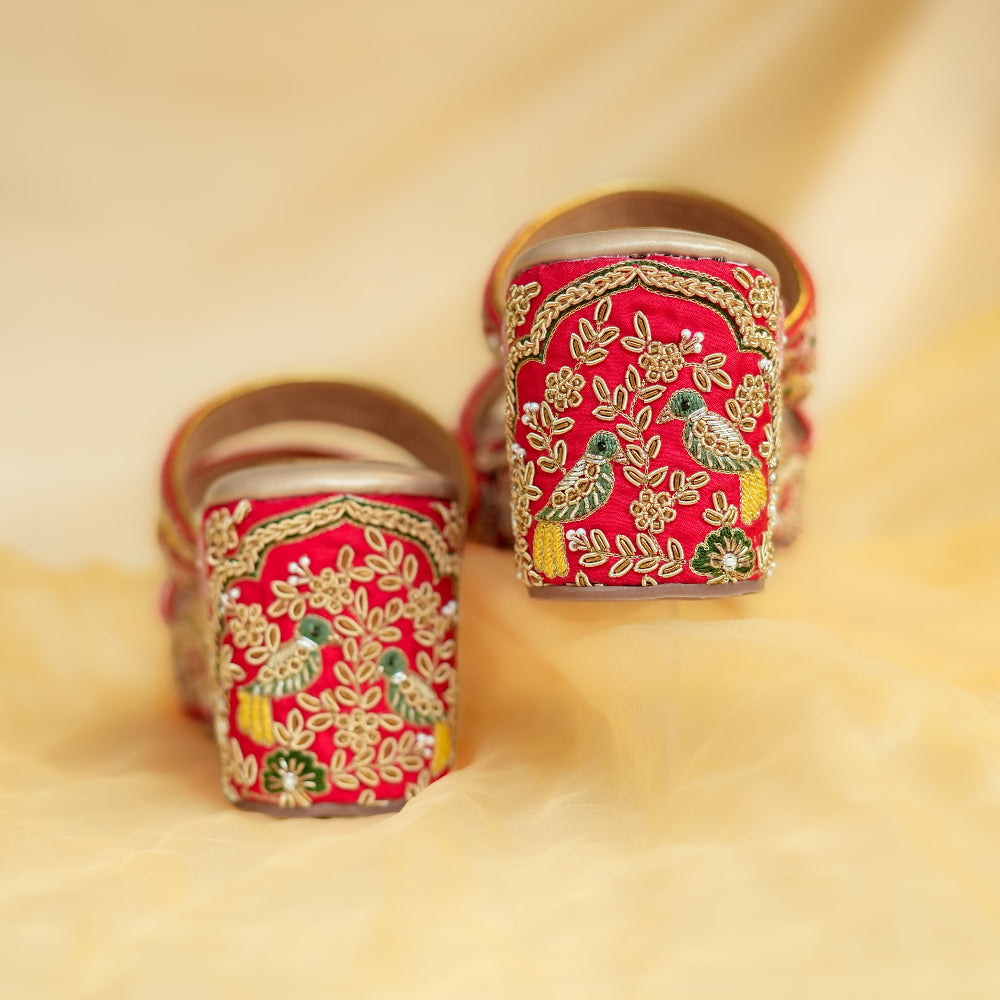 Hand-embroidered red wedges featuring floral artwork and lightweight platform
