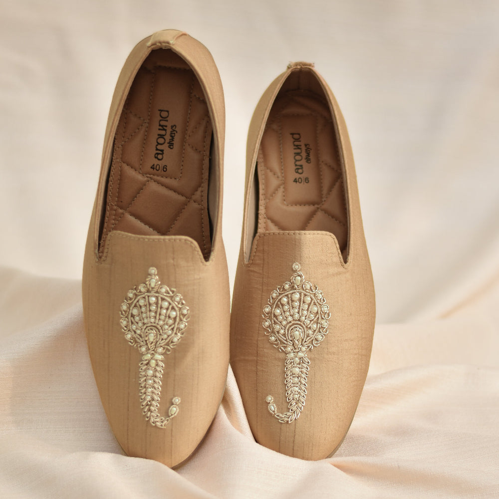 Classic slip-ons with sculpted central embellishment