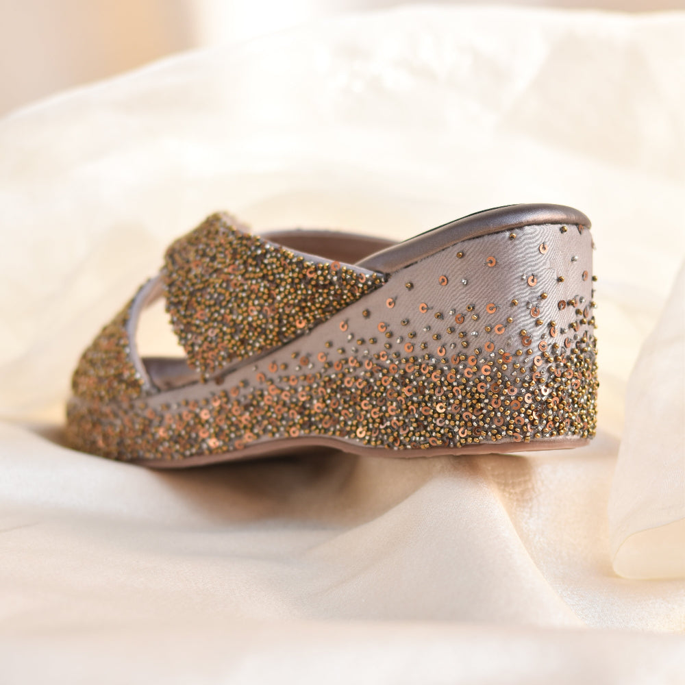 Festive platform sandals styled on fabric backdrop with sequin surface
