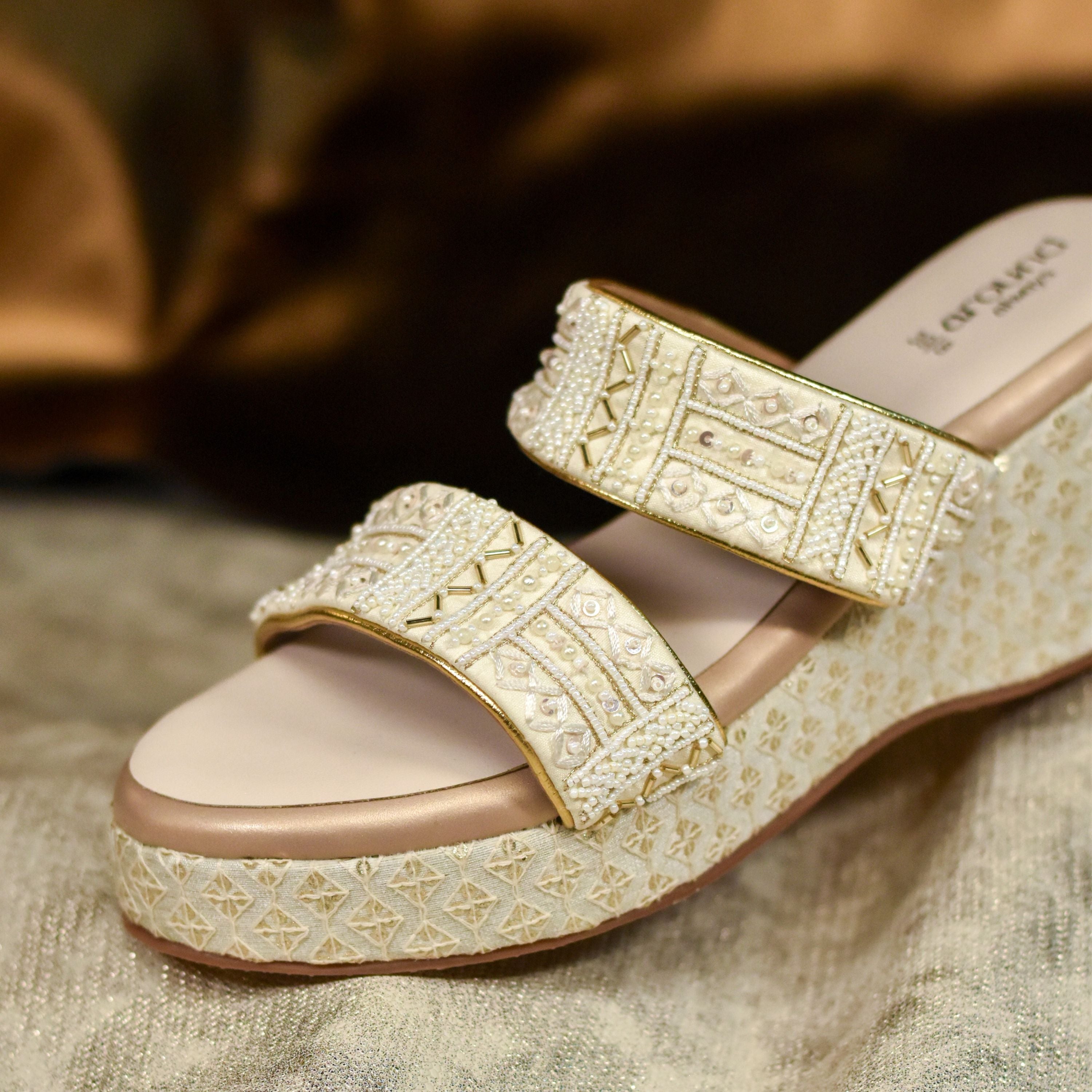 Designer golden wedge footwear with twin straps for weddings.