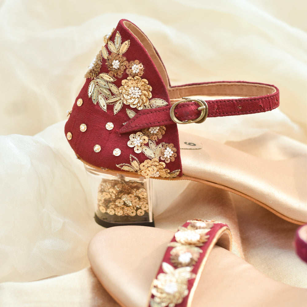 Festive wine heels styled on soft fabric backdrop