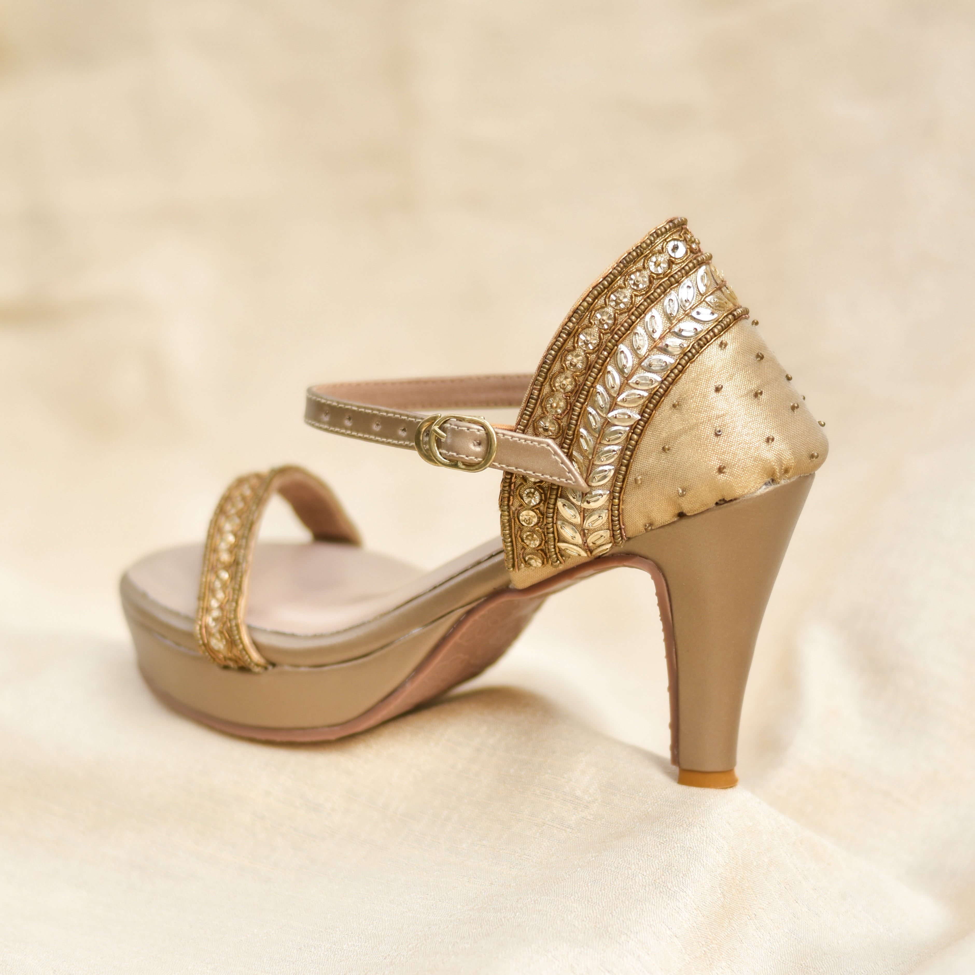 Party heels for women in gold with sequin detailing and platform base.