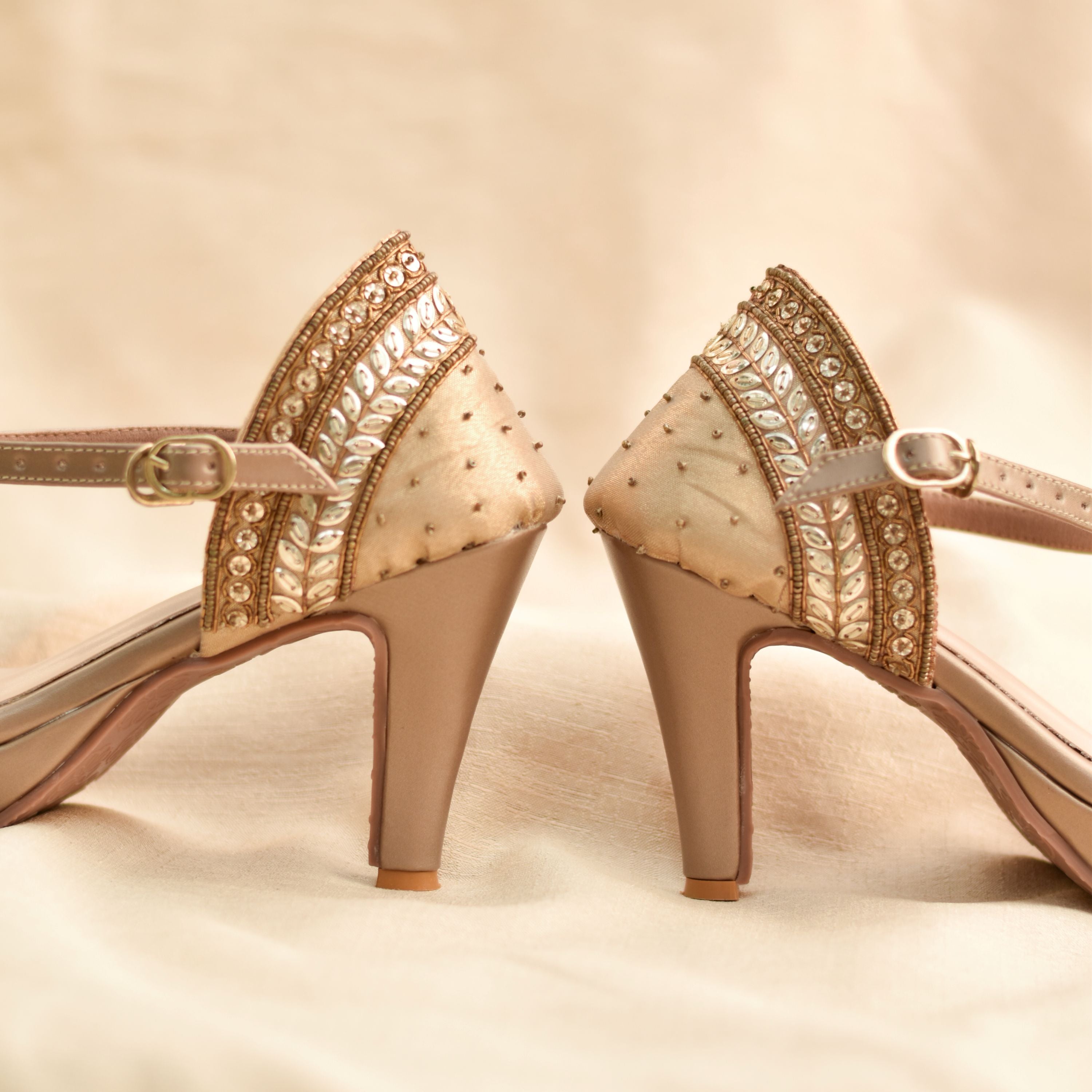 Shimmering gold high heels for festive and wedding wear.