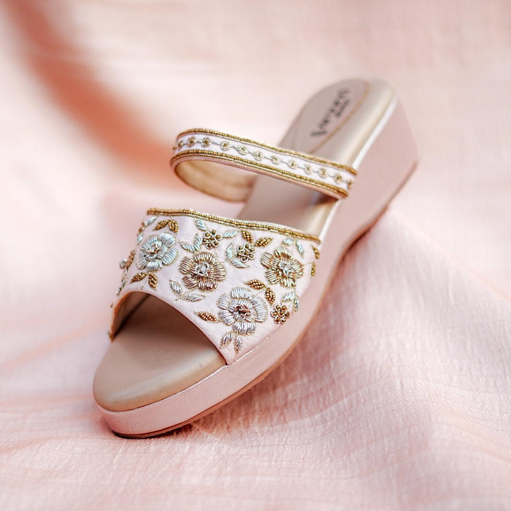 Elegant embroidered platform wedge featuring delicate floral patterns and subtle metallic accents