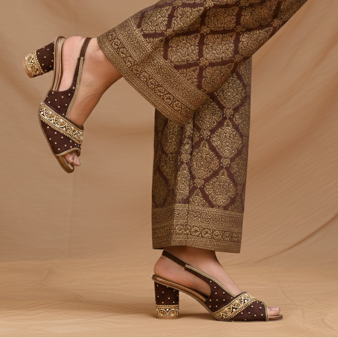 Embellished slingback sandals with open toe and decorated block heel.