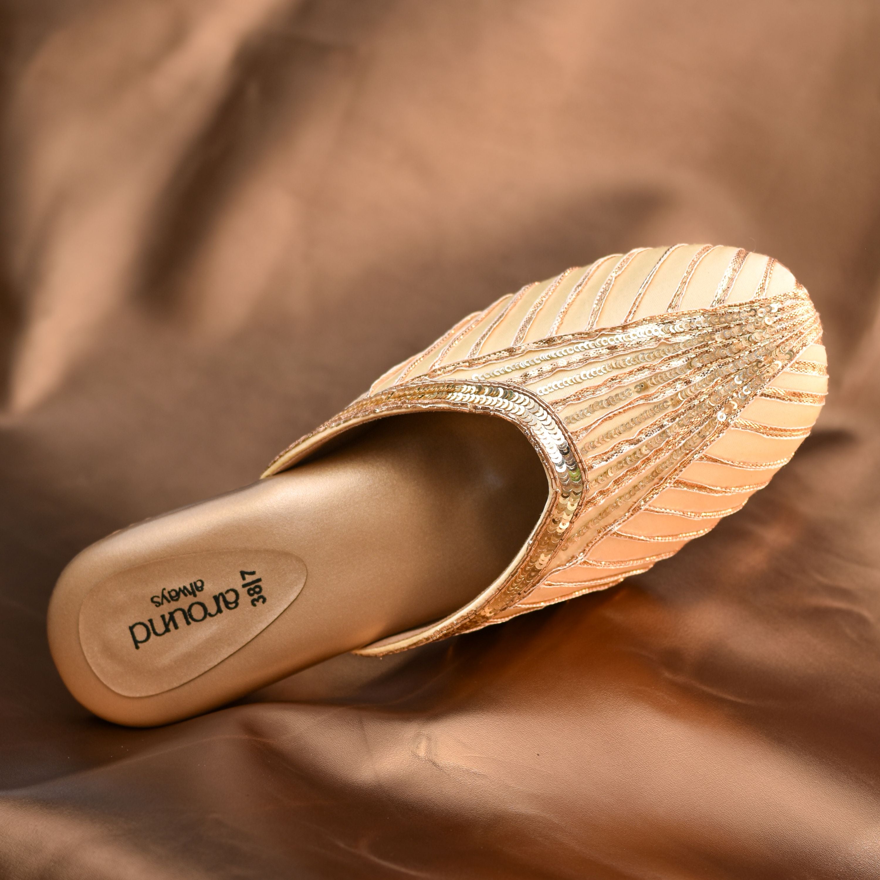 Sequined satin mule with structured block heel design.