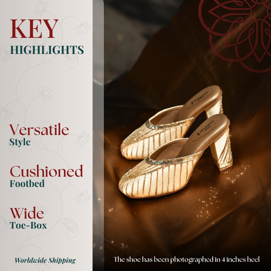 Gold toned mule heels with vertical metallic stripes and a softly cushioned footbed
