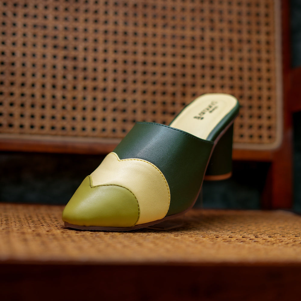 Geometric color-block forest green mules with a pointed toe and elevated heel.