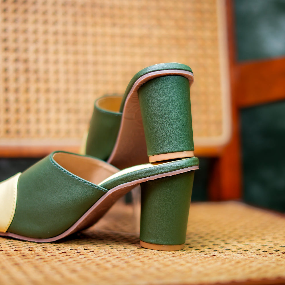 Green heeled mules with geometric color-block detailing and a pointed toe.