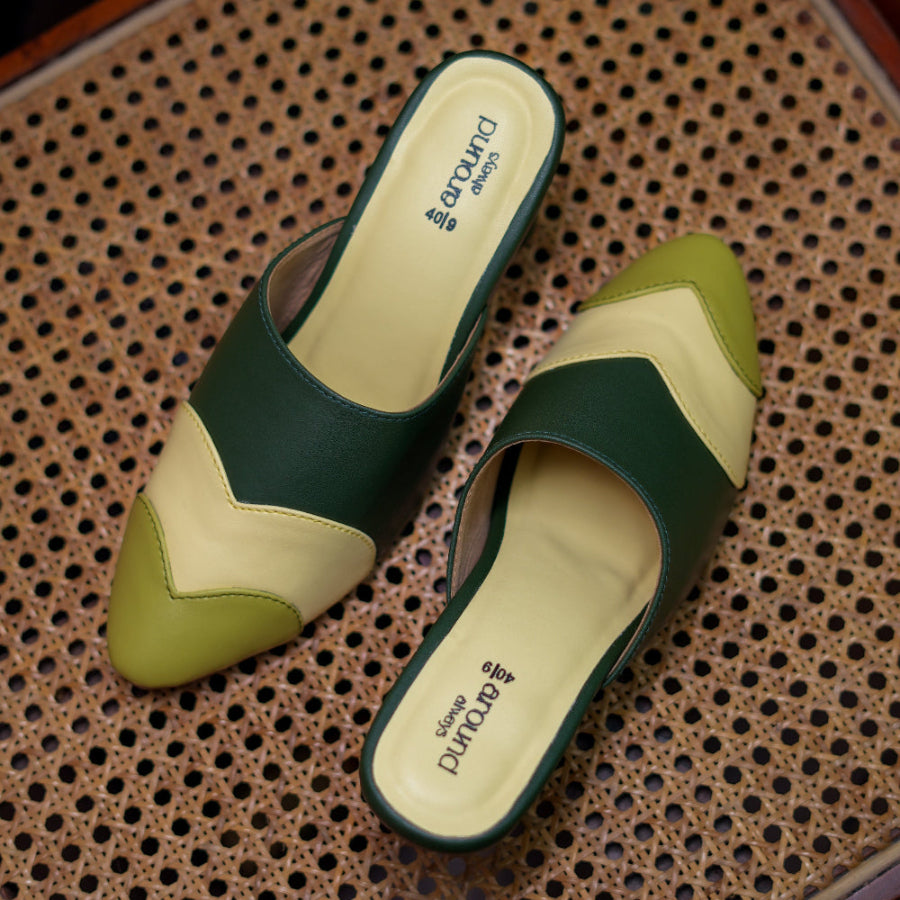 Forest green mules with a pointed toe, block heel, and geometric color blocking.