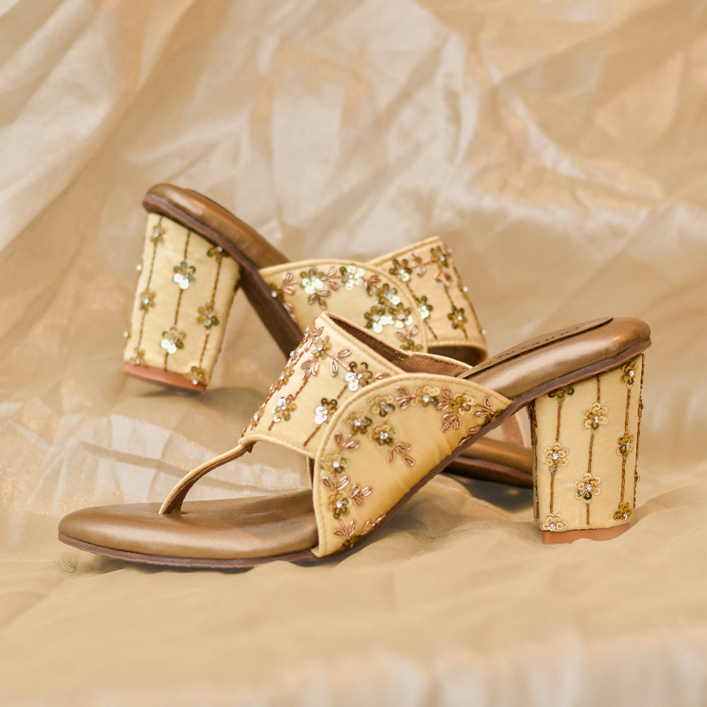 Women's festive gold block heels with embroidered floral design.
