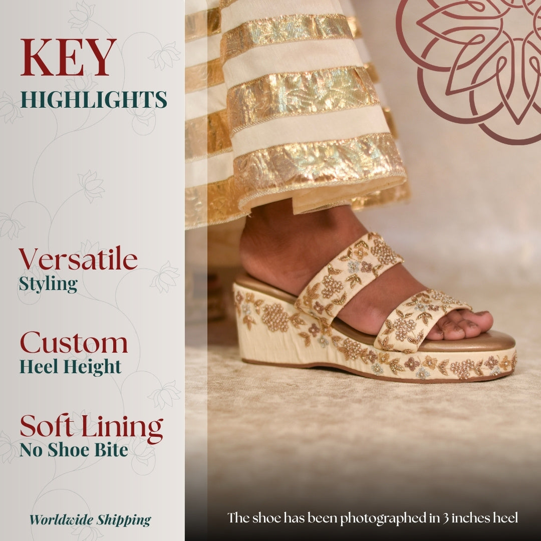 Cream wedge with dual embroidered straps, soft footbed, and cushioned sole offering comfort and elegant styling.