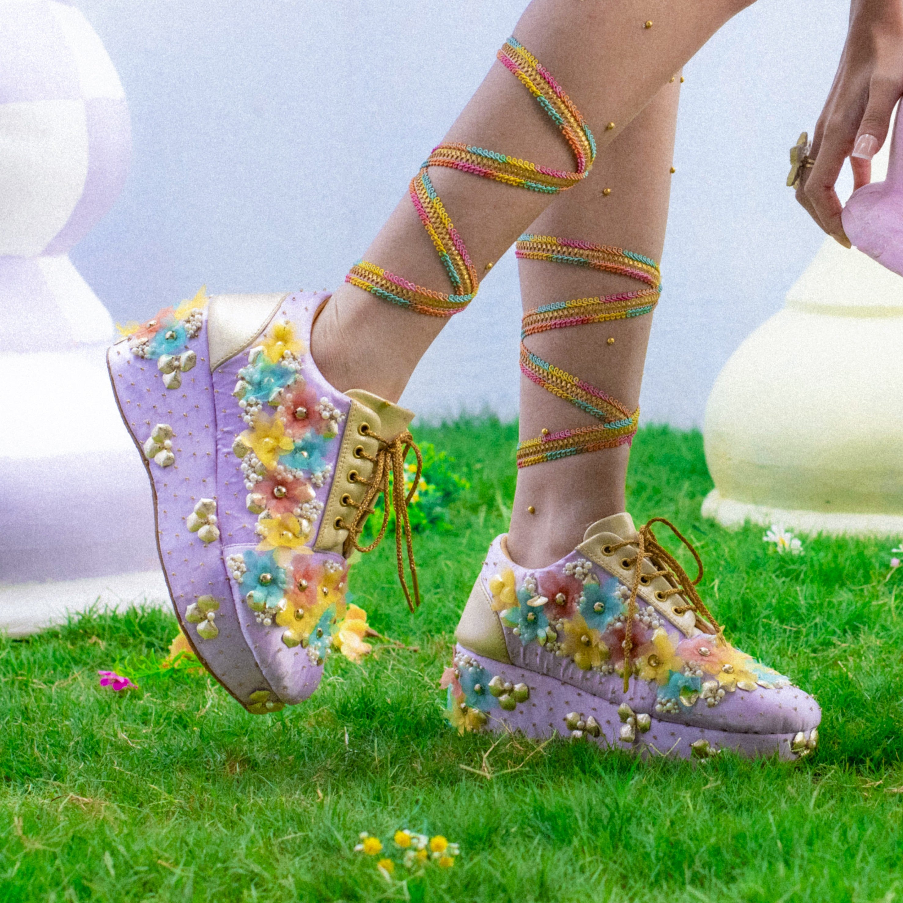 Lilac platform sneakers with pastel floral appliqué and gold laces on cushioned base