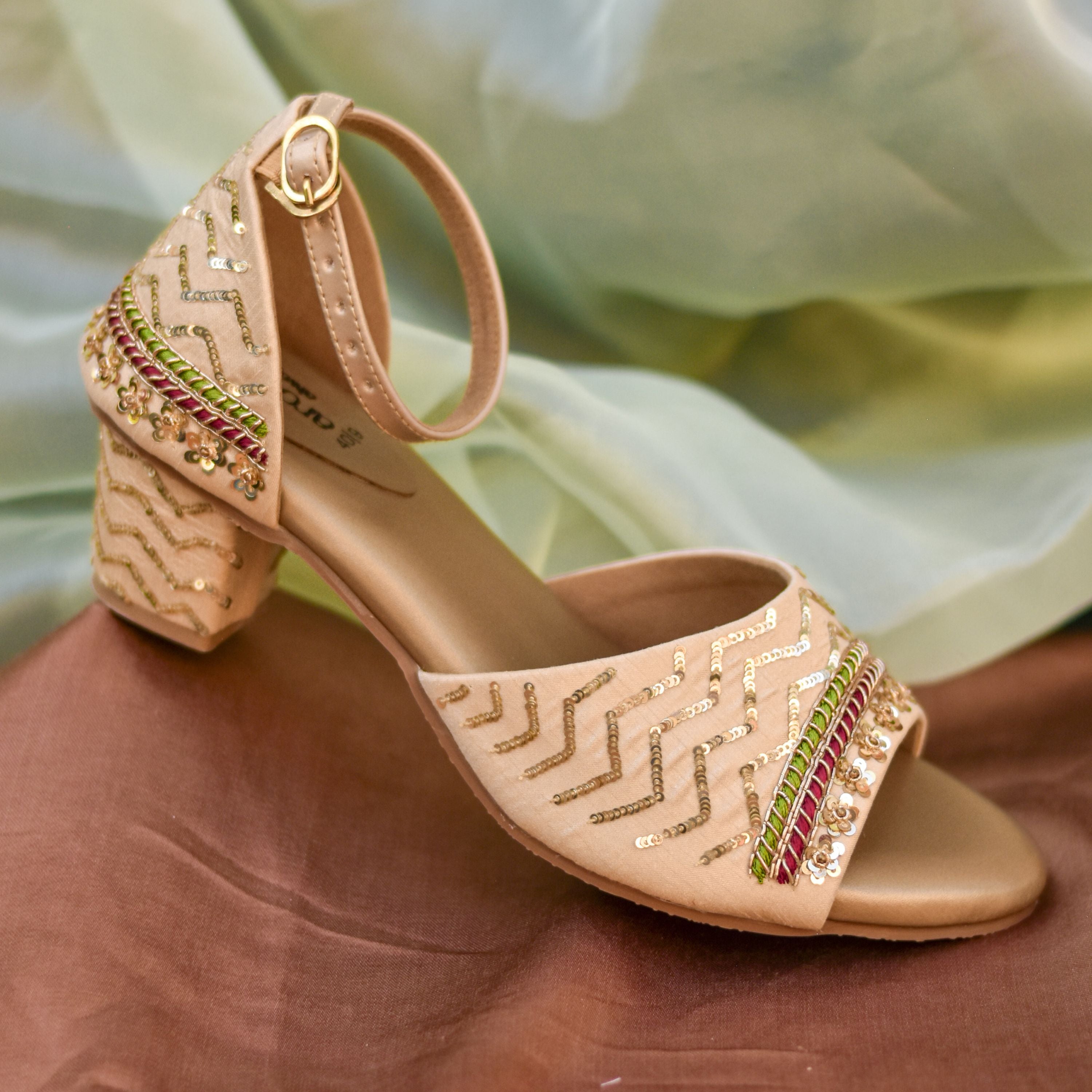 Festive women’s heels in beige with red and green highlights.