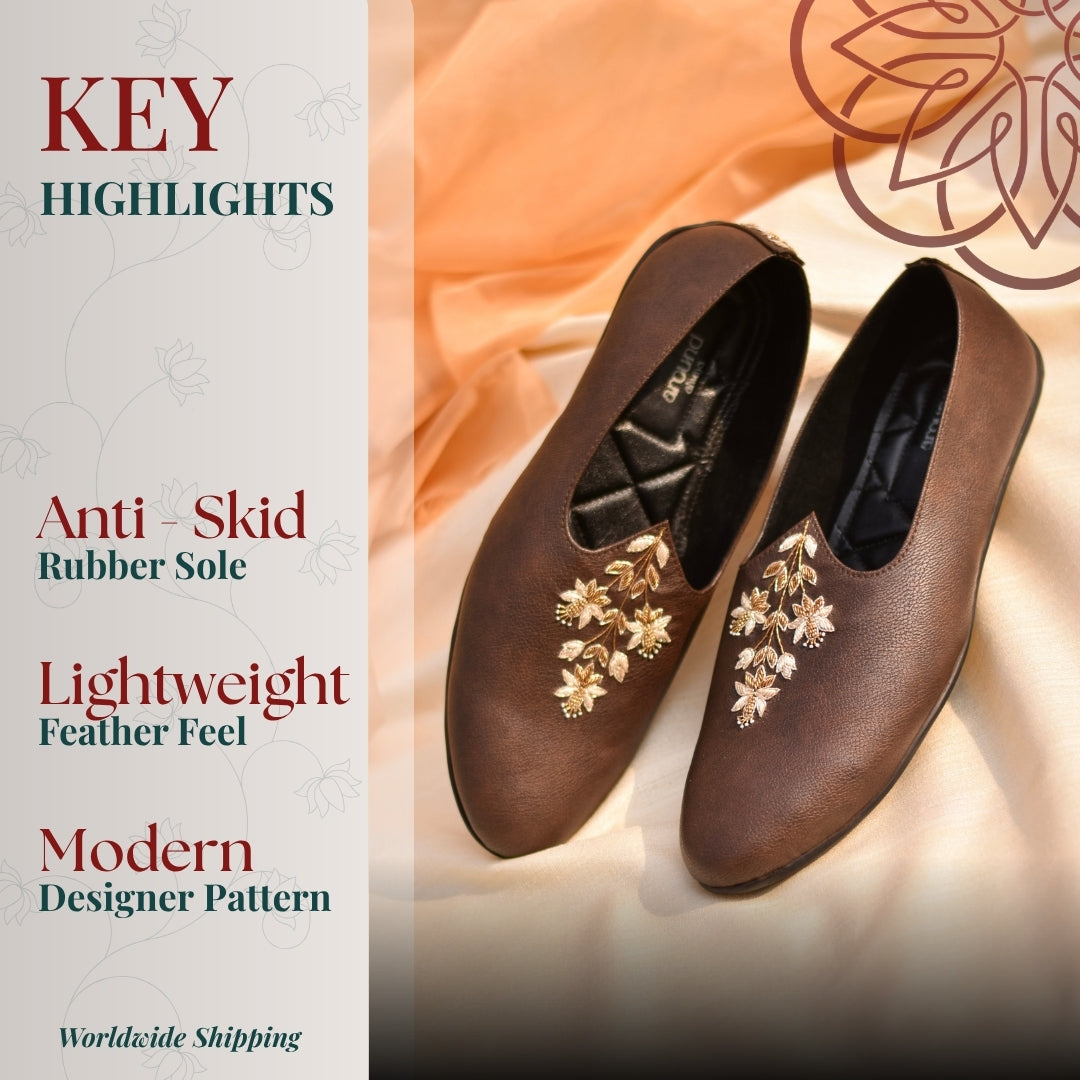 Velvet mojris with regal zardozi detailing, crest motifs, and comfortable cushioned sole