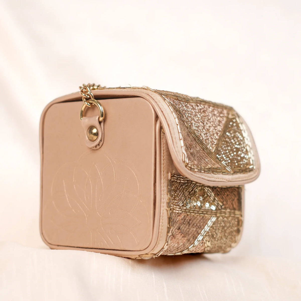 Side view of the Amyra box clutch with pressed flower design and gold chain hook