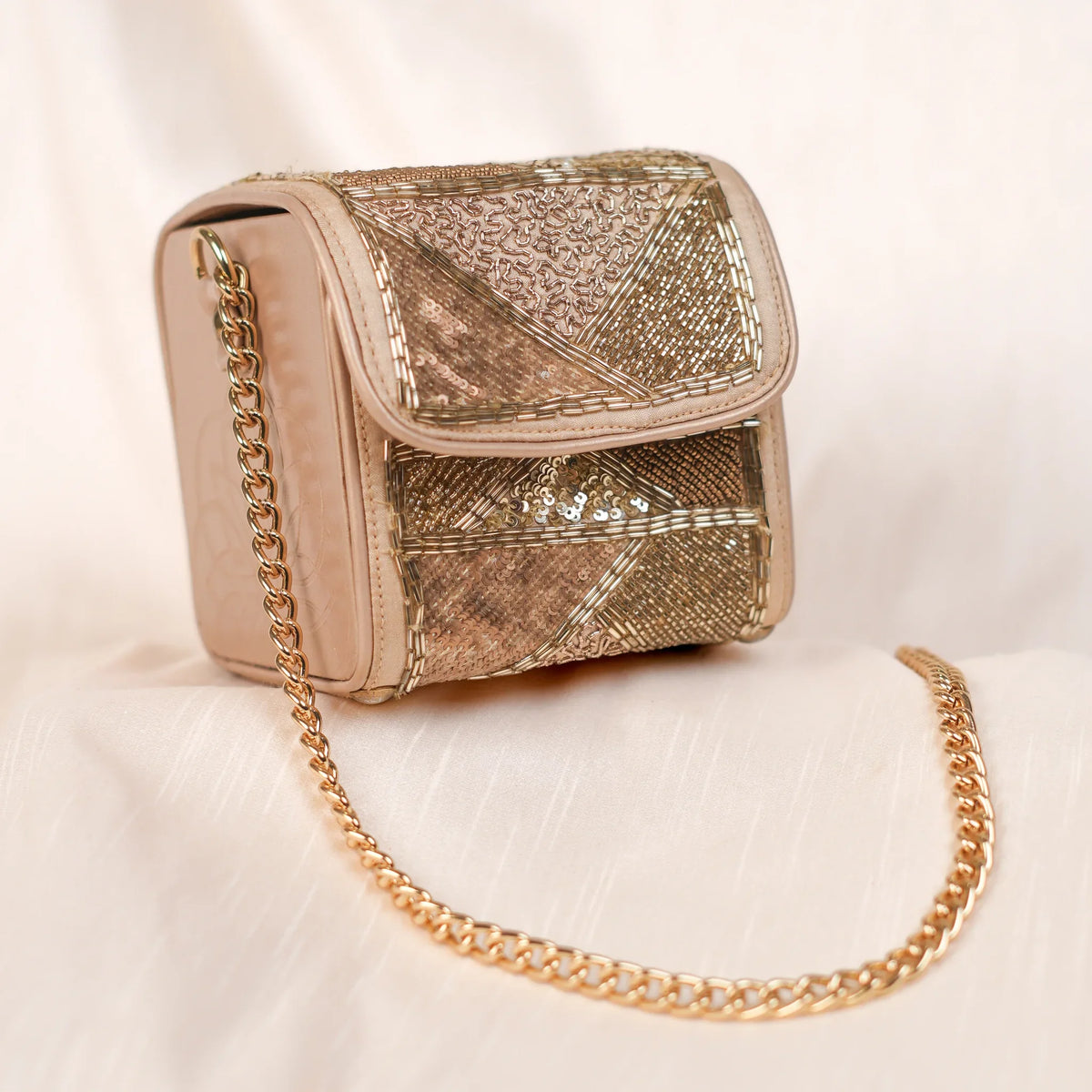 Rose gold sequin box bag with front flap and long gold chain strap