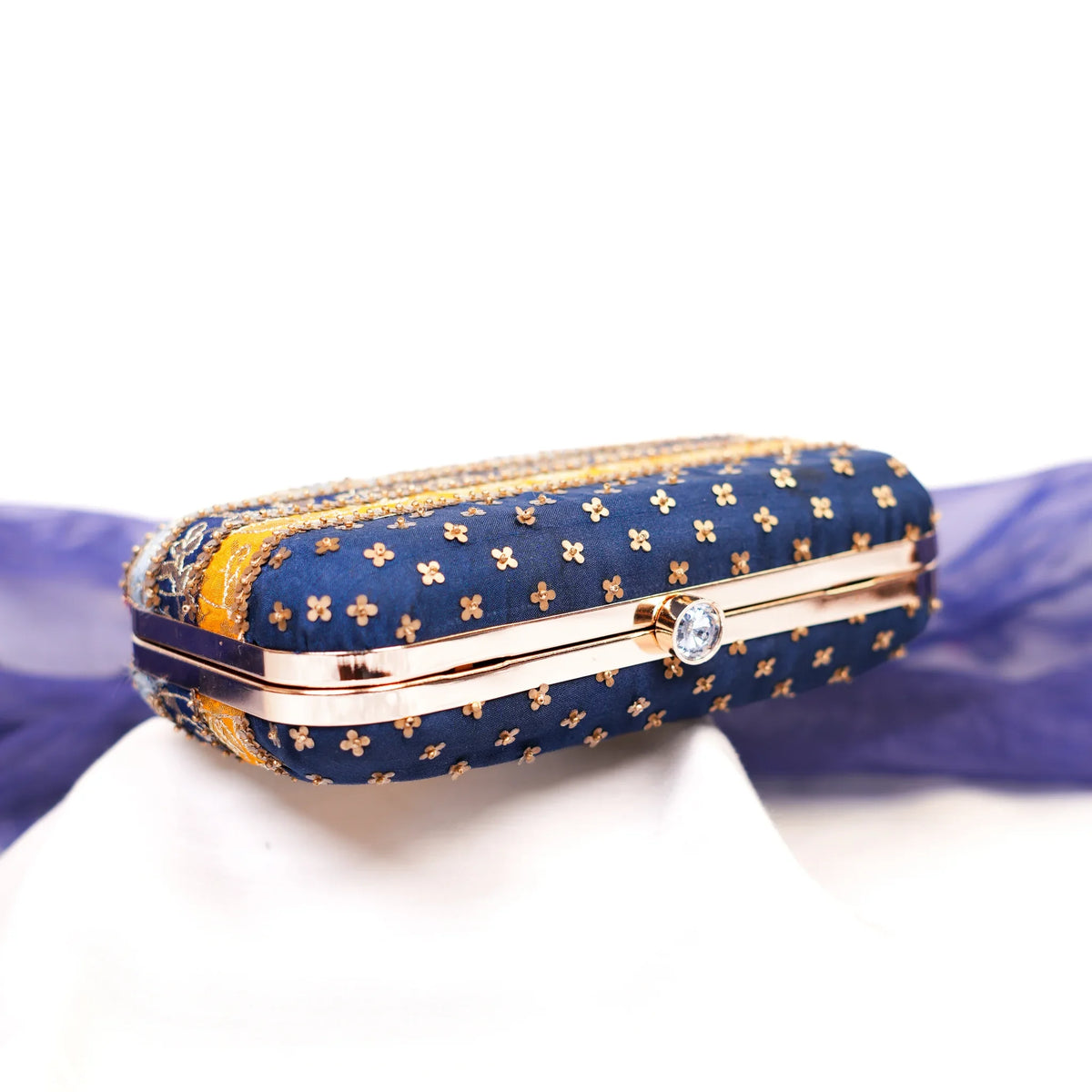 Top view of the Assi clutch with navy sequin buttis and crystal clasp