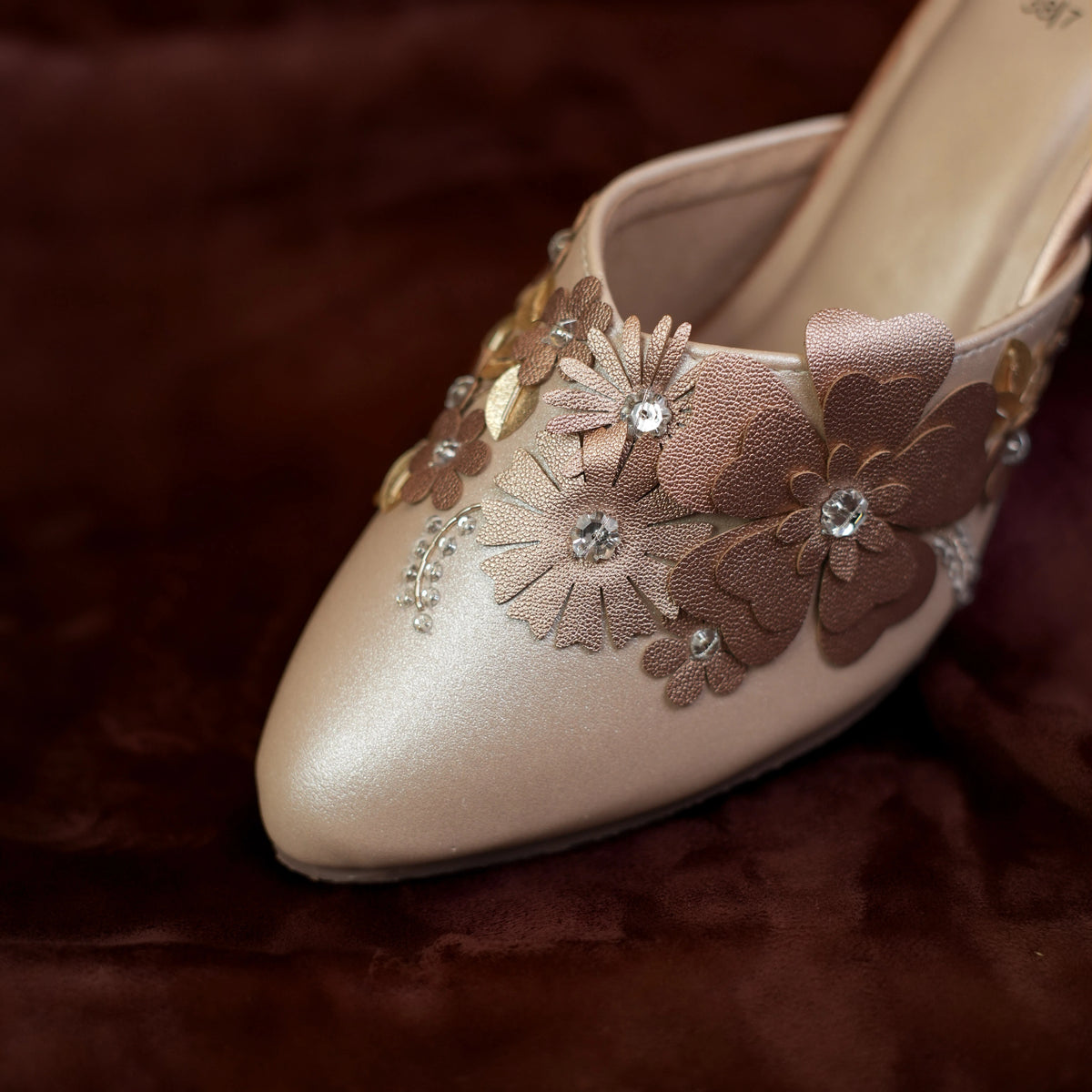 Close up of 3D flower applique, crystal and sequin embroidery on champagne wedding mules