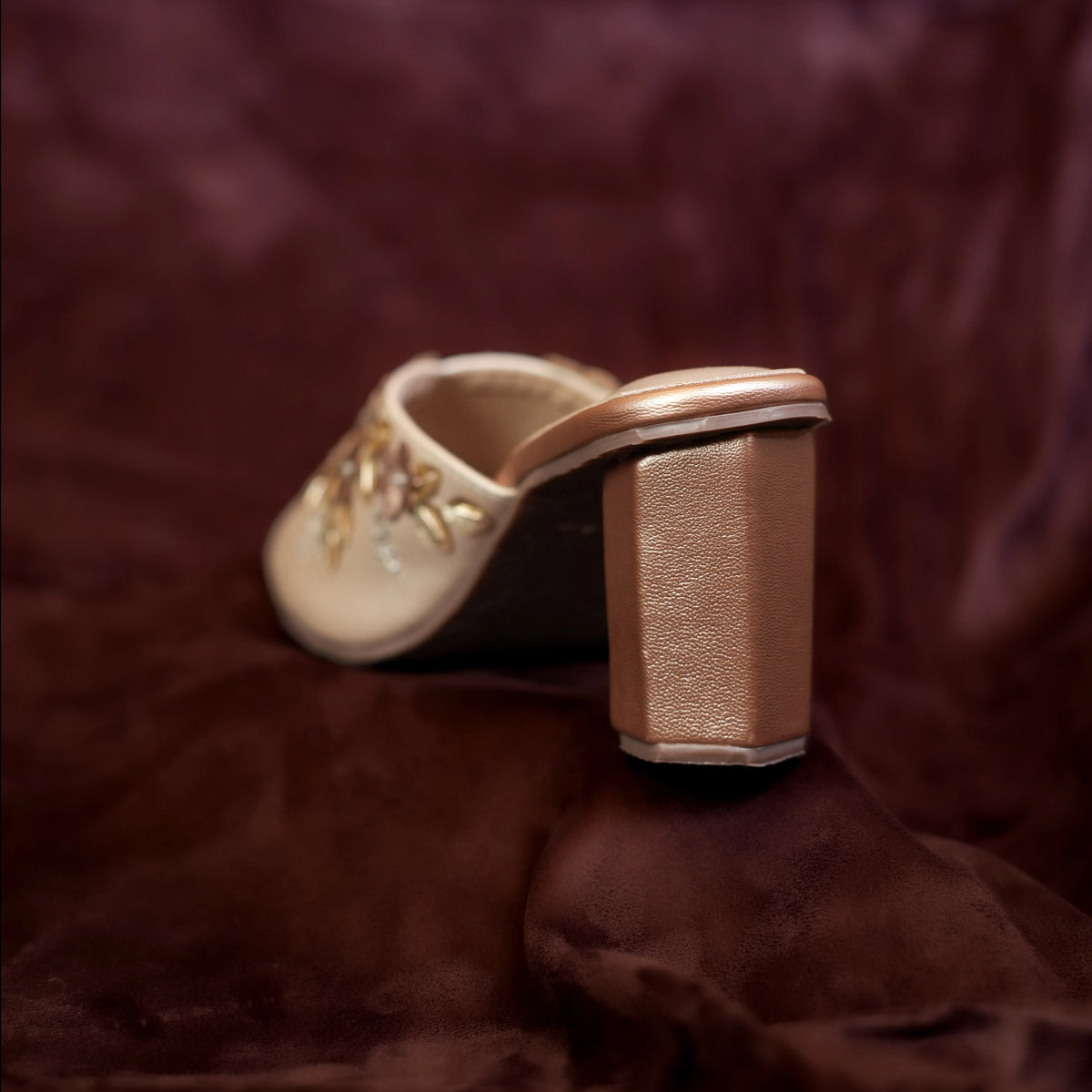 Back view of Aura mules showing the rose gold hexagonal block heel
