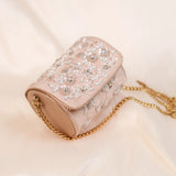 Blush pink barrel bag with hand embroidered vines and long gold chain