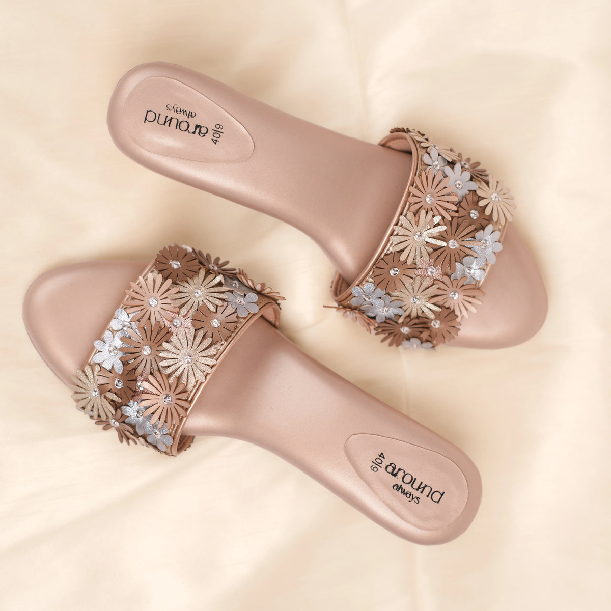 Top view of Eden blush beige sandals with gold and silver 3D flower strap and cushioned footbed