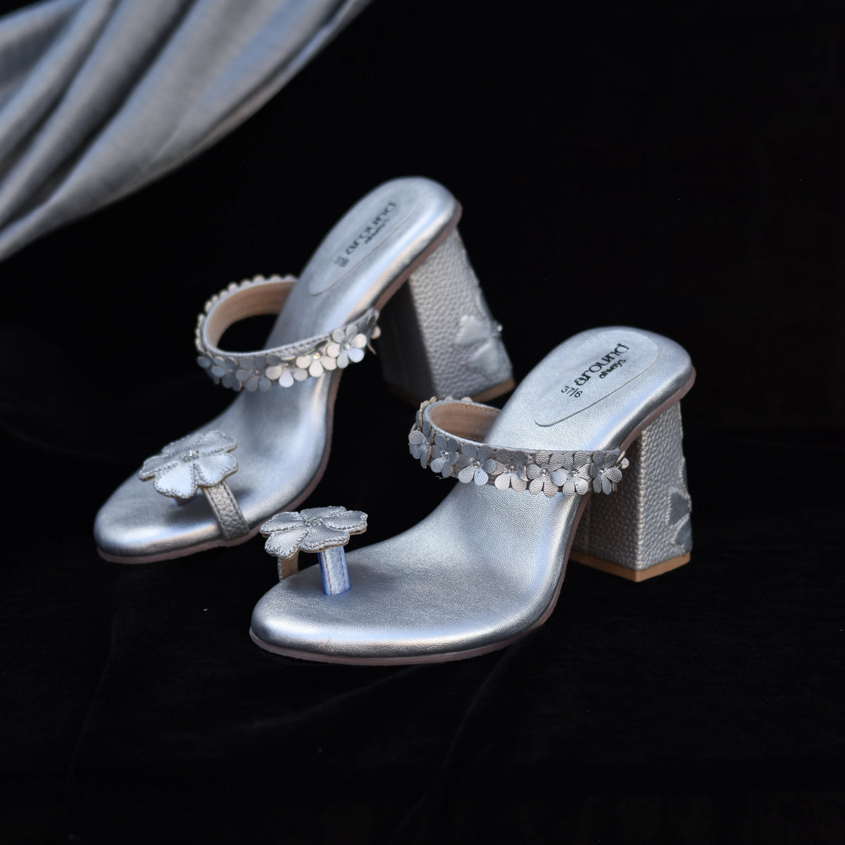 Silver Kolhapuri-style sandals with 3D floral embellishments