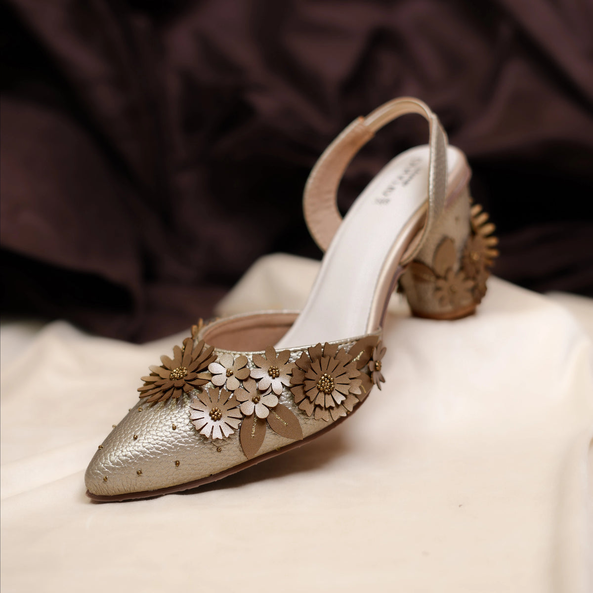 Metallic pointed-toe mules with 3D floral embellishments