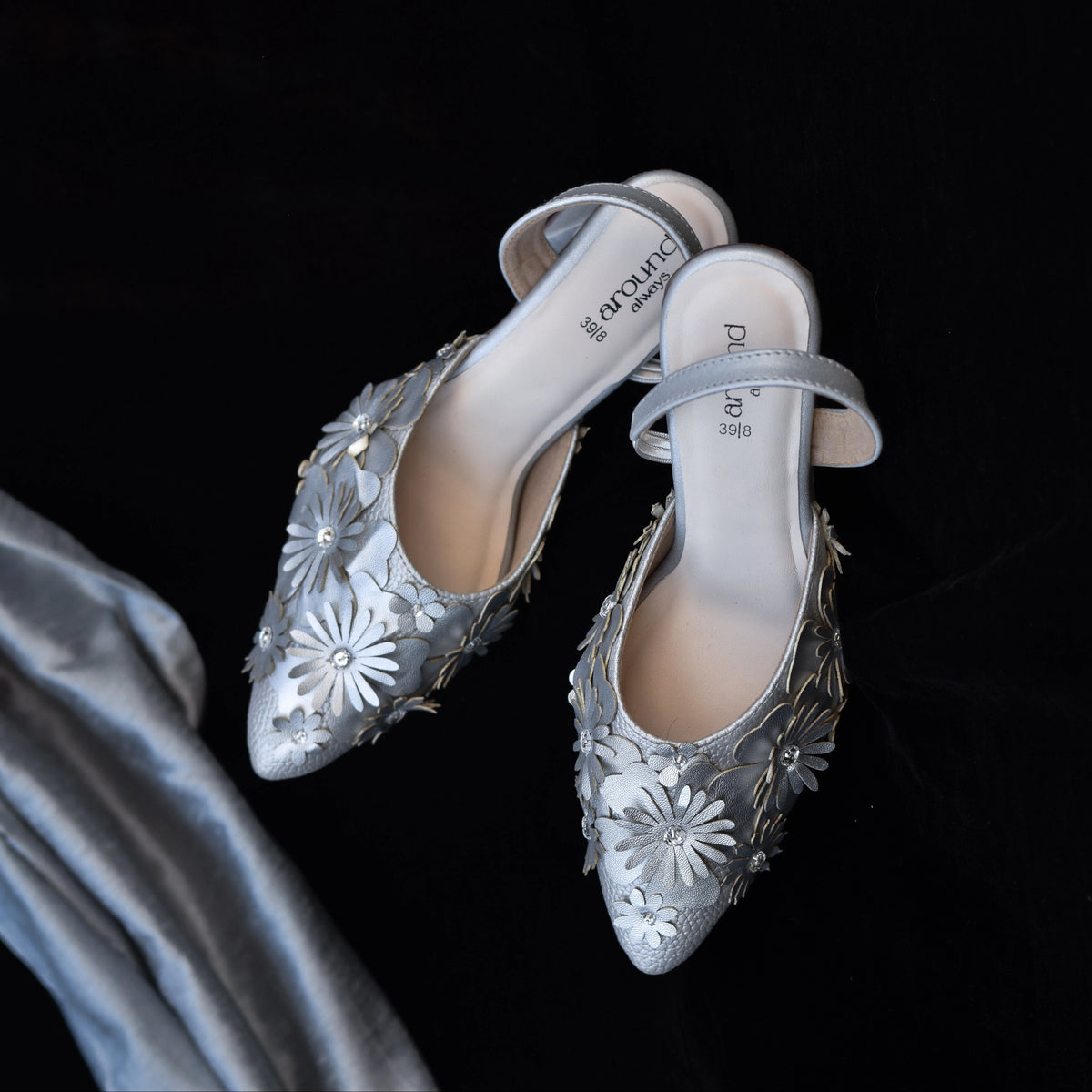Silver pointed-toe slingback heels with layered flower detailing