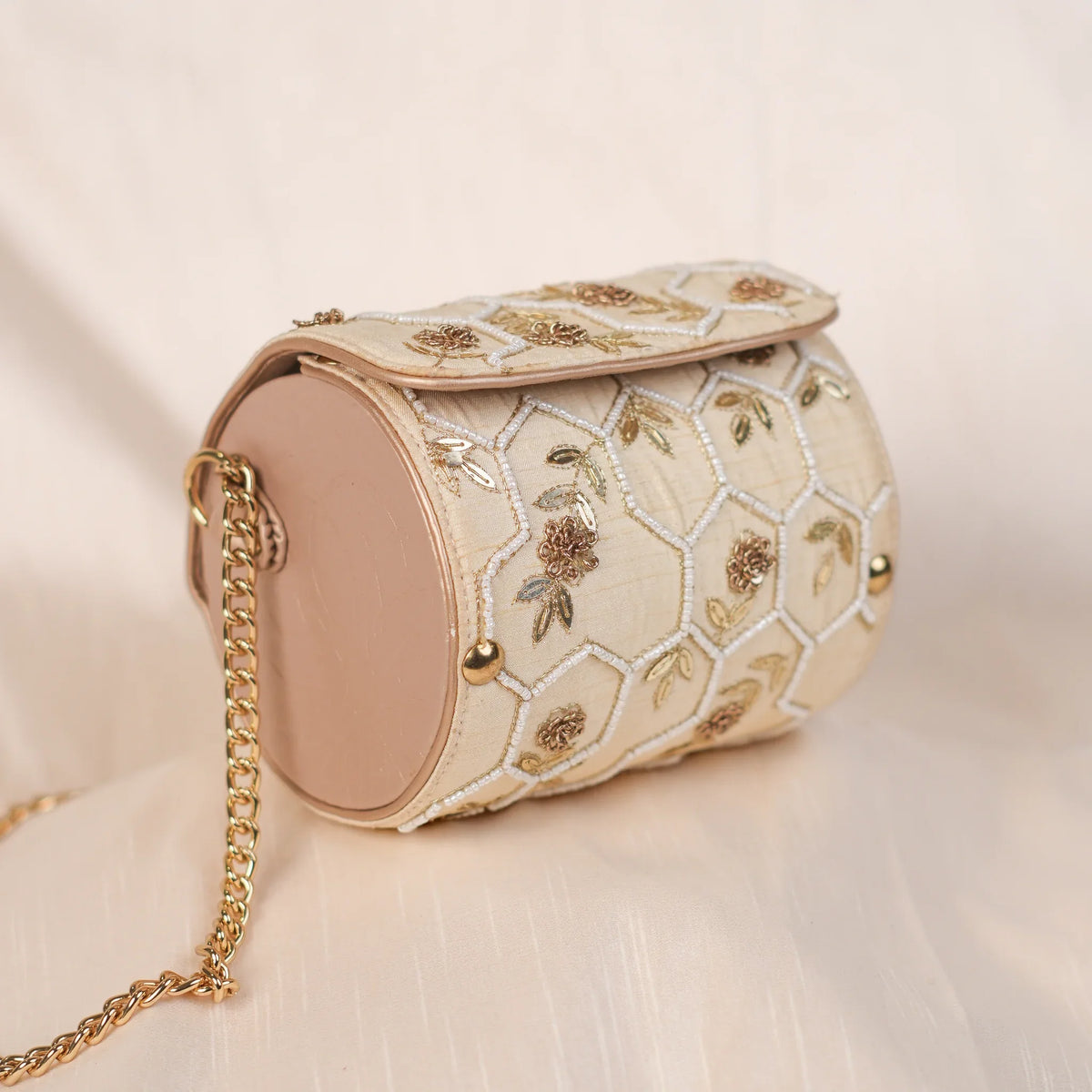 Honeycomb cream circle clutch with hexagon thread work and zardozi roses
