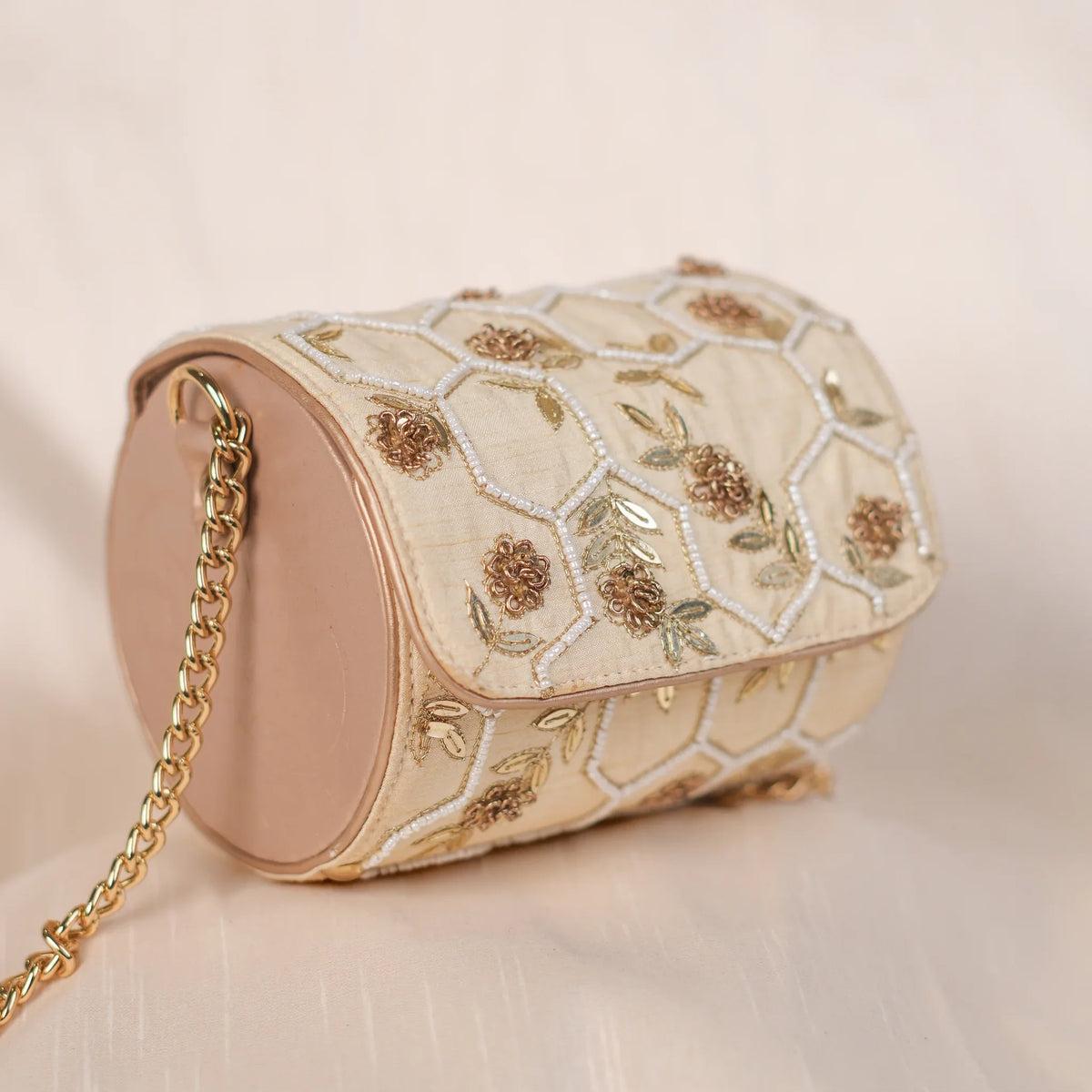Honeycomb barrel clutch with gold chain, angled front view