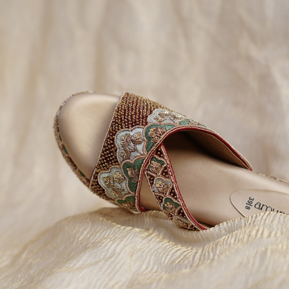 Close up of hand-set beads on maroon cross strap platform