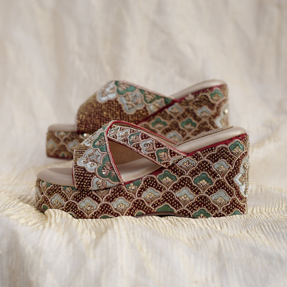 Side profile of maroon designer wedges with beaded pattern
