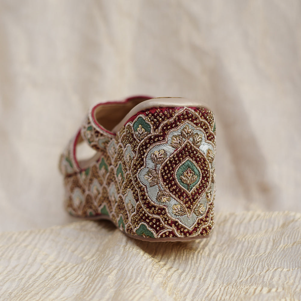 Medallion bead work on the back of a maroon bridal platform heel