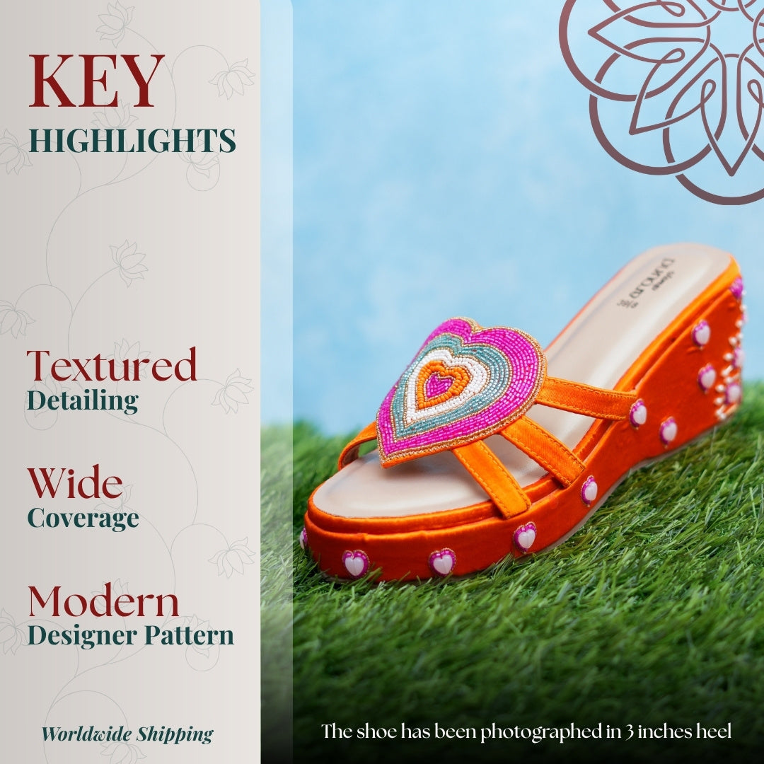 Vibrant orange platform sandal with multicolour heart detail, textured sole, and cushioned footbed