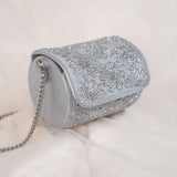 Round silver end of the Moonflower clutch with pressed flower pattern