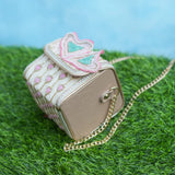 Champagne side of the Moxy bag with pressed flower design and chain