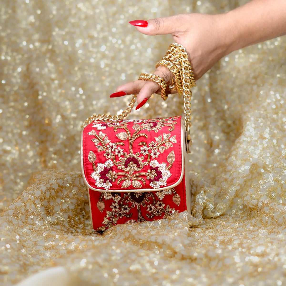 Naina box bag with gold chain wrapped around the wrist