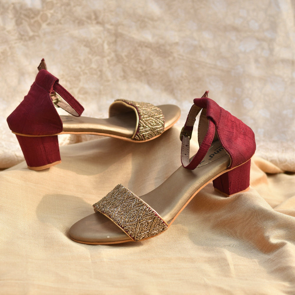 Bridal maroon heels styled with neutral outfit on studio setup