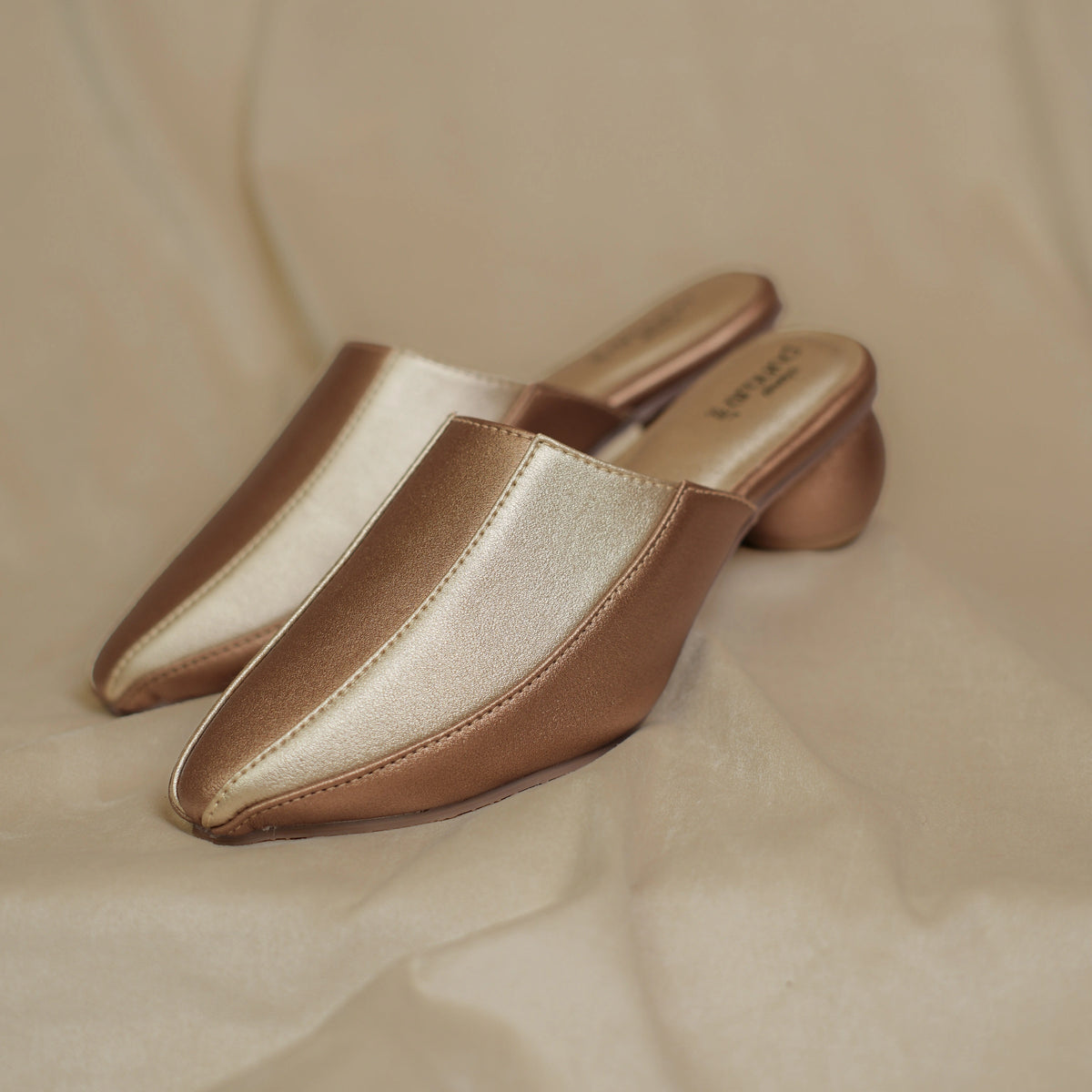 Pair of metallic two tone mules for women, front view