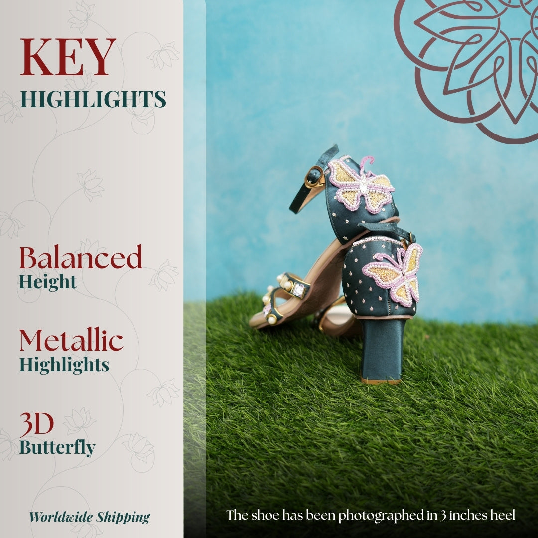 Teal sandal with metallic dual straps, ankle buckle, flared heel, and 3D butterfly detail