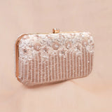 Savera ivory bridal clutch with hand embroidered white flowers and rose gold sequin stripes, front view