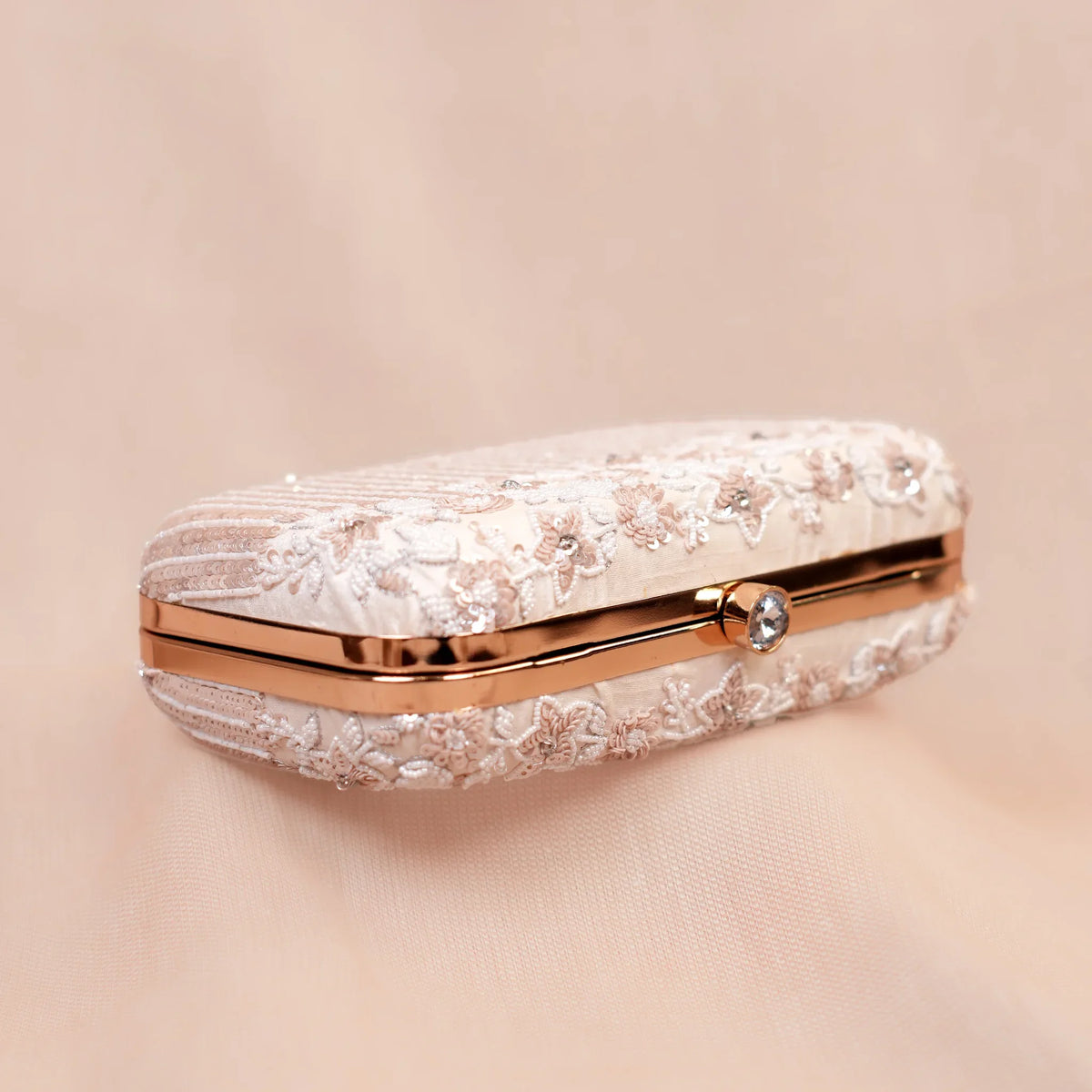 Top view of the Savera ivory clutch with rose gold frame and crystal clasp