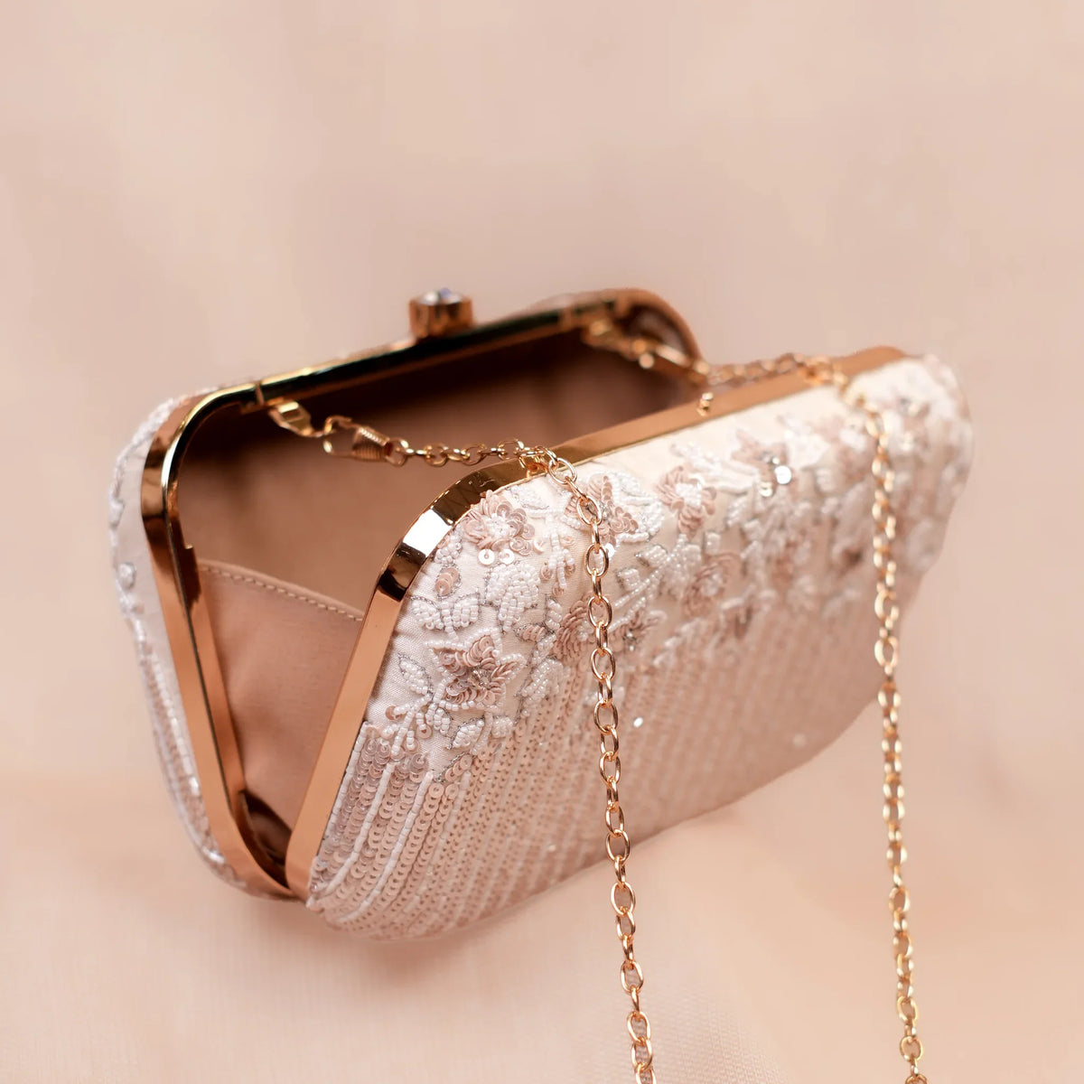 Open ivory wedding clutch with gold chain strap for lehenga and saree looks