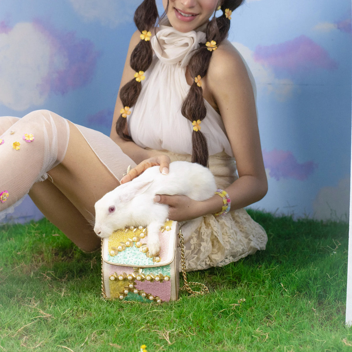 Sugar pastel bag held in the lap with a cream outfit