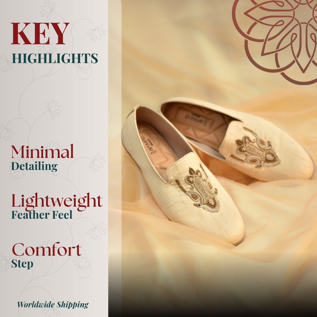 Festive beige footwear with metallic embroidered motifs and flexible flat sole